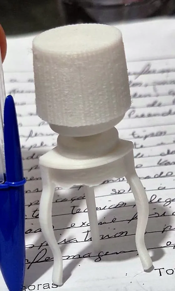 Mesinha branca em miniatura com pés curvos e tampo cilíndrico, impressa em 3D